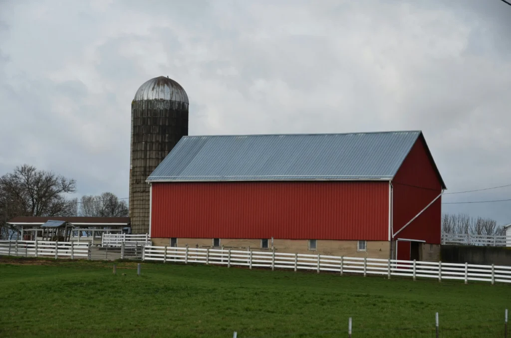 Red barn with silo in a field